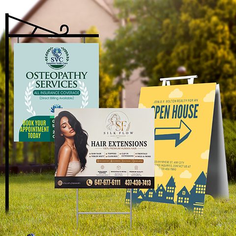 Three printed lawn signs standing on a front lawn